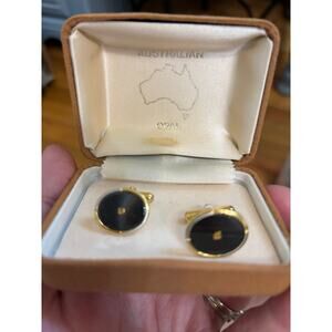 Vintage Celine cufflinks featuring a black onyx stone set in gold and silver